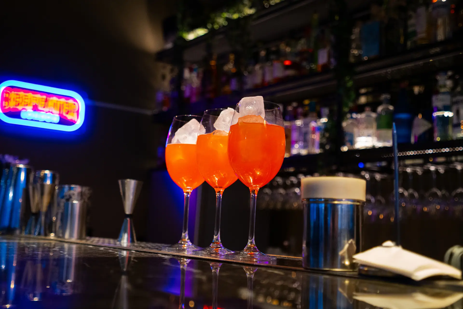 The Artist hotel bar — colourful bottles and Aperol Spritz, the venue after cooking